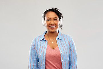 Image showing african woman in headphones listening to music