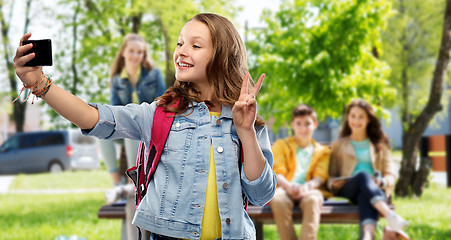 Image showing teenage student girl taking selfie by smartphone