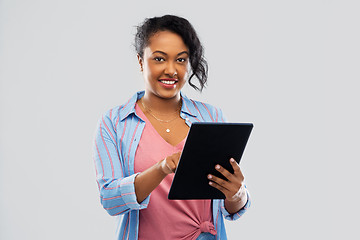 Image showing happy african american woman using tablet pc