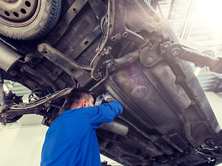 Image showing mechanic man or smith repairing car at workshop