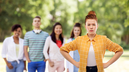 Image showing displeased redhead teenage girl with hands on hips