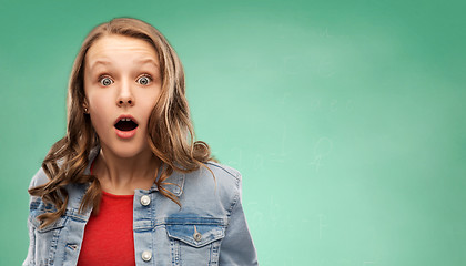 Image showing surprised student girl over green background