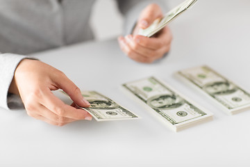 Image showing close up of woman hands counting us dollar money