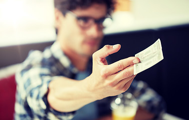 Image showing man with cash money paying at cafe