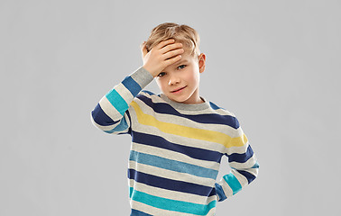 Image showing sick boy in red t-shirt suffering from headache