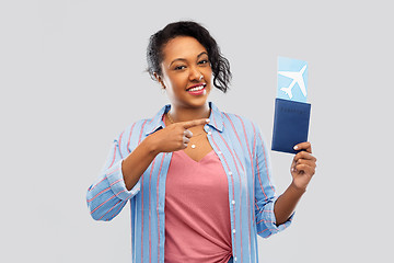 Image showing african woman with passport and air ticket