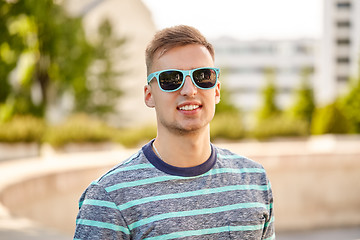 Image showing portrait of young man in sunglasses at summer city