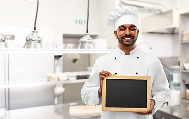 Image showing indian chef with chalkboard at restaurant kitchen