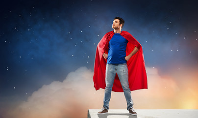 Image showing man in red superhero cape over night sky