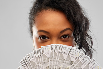 Image showing african american woman hiding face behind money