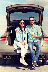 Image showing happy couple with coffee at hatchback car trunk