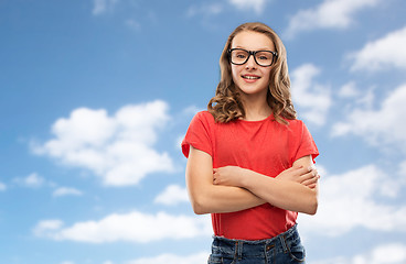 Image showing smiling student girl in glasses over sky