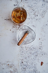 Image showing Whiskey or brandy in a glass with Cuban cigar