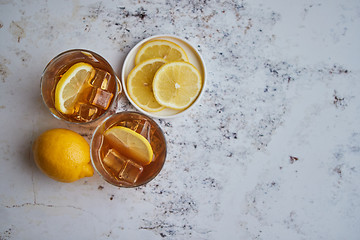 Image showing Whiskey sour drink with lemon in glass on stone rustical background