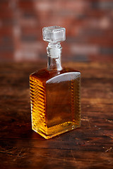 Image showing Bottle of whiskey on wooden table