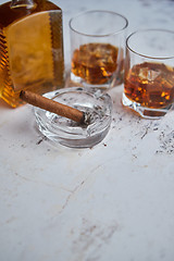 Image showing Bottle and glasses of brandy or wiskey and nice big cuban cigar