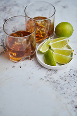 Image showing Whiskey sour drink with lemon in glass on stone rustical background