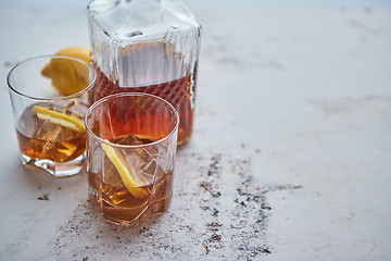 Image showing Whiskey sour drink with lemon in glass on stone rustical background