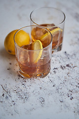 Image showing Whiskey sour drink with lemon in glass on stone rustical background