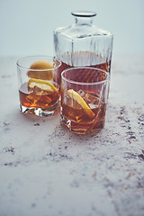 Image showing Whiskey sour drink with lemon in glass on stone rustical background