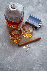 Image showing Two glasses of old whiskey with cuban cigar and carafe