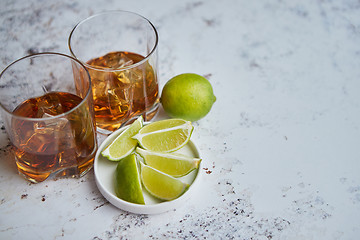 Image showing Whiskey sour drink with lemon in glass on stone rustical background