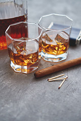 Image showing Two glasses of old whiskey with cuban cigar and carafe