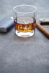 Image showing Glass of whiskey with ice, big cuban cigar, matches and hip flask