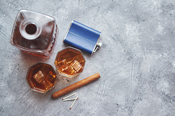 Image showing Two glasses of old whiskey with cuban cigar and carafe