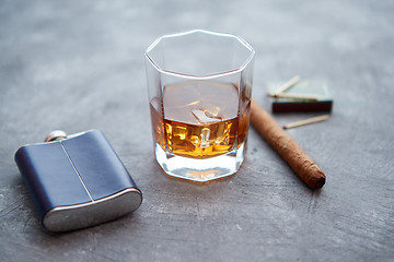 Image showing Glass of whiskey with ice, big cuban cigar, matches and hip flask