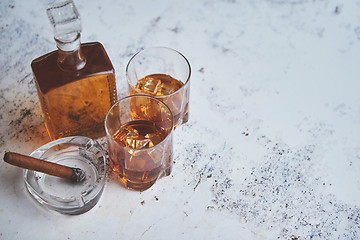 Image showing Bottle and glasses of brandy or wiskey and nice big cuban cigar