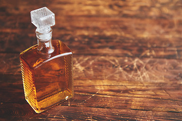 Image showing Bottle of whiskey on wooden table