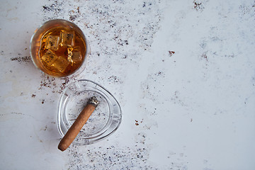 Image showing Whiskey or brandy in a glass with Cuban cigar