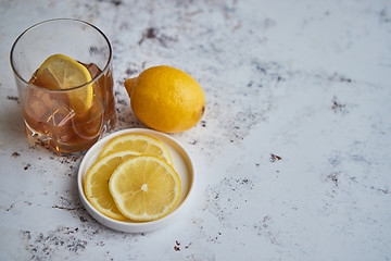 Image showing Whiskey sour drink with lemon in glass on stone rustical background