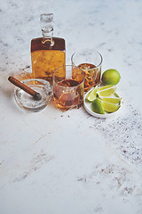 Image showing Whiskey sour drink with lemon in glass on stone rustical background