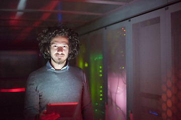 Image showing IT engineer working on a tablet computer in server room