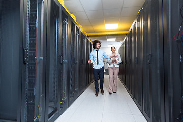 Image showing engineer showing working data center server room to female chief