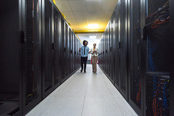 Image showing engineer showing working data center server room to female chief