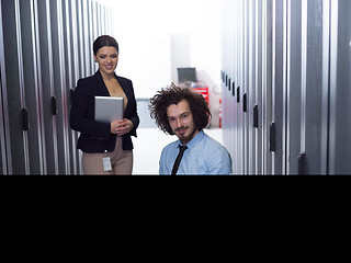 Image showing Team of young technicians working together on servers