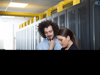 Image showing engineer showing working data center server room to female chief