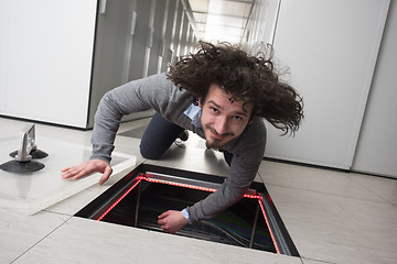 Image showing engineer connecting cables in server room