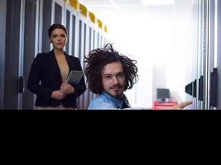 Image showing Team of young technicians working together on servers