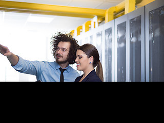 Image showing engineer showing working data center server room to female chief