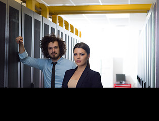 Image showing engineer showing working data center server room to female chief