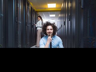 Image showing young technicians working together on servers