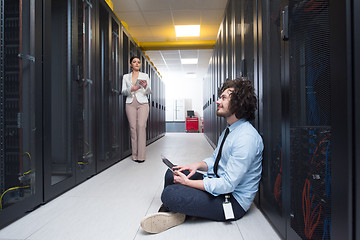 Image showing young technicians working together on servers