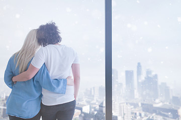 Image showing young couple enjoying morning coffee by the window