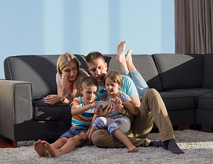 Image showing happy young couple spending time with kids