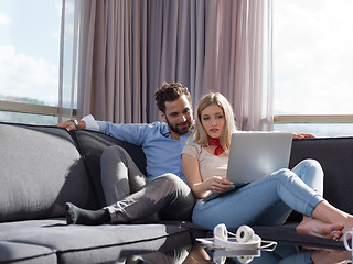 Image showing couple relaxing at  home using laptop computer