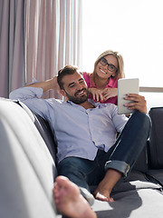 Image showing couple relaxing at  home with tablet computers